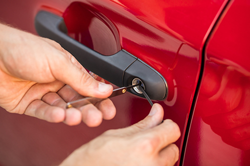 image of a car door lock being picked because the keys have been locked inside