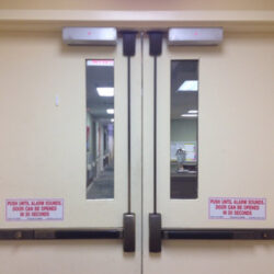 Commercial doors with mag locks at the top and crash bars